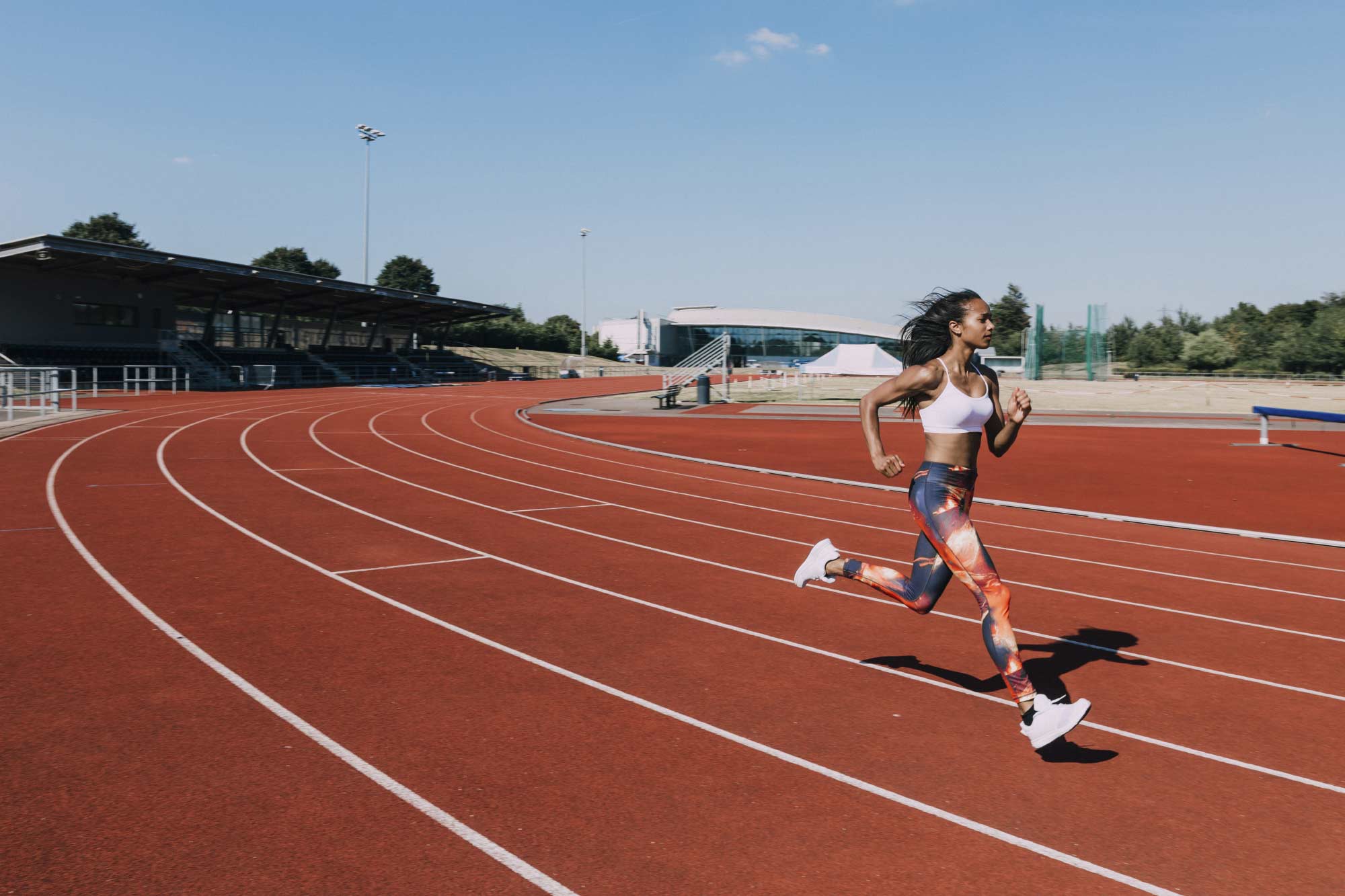 Woman running confidently on a track
