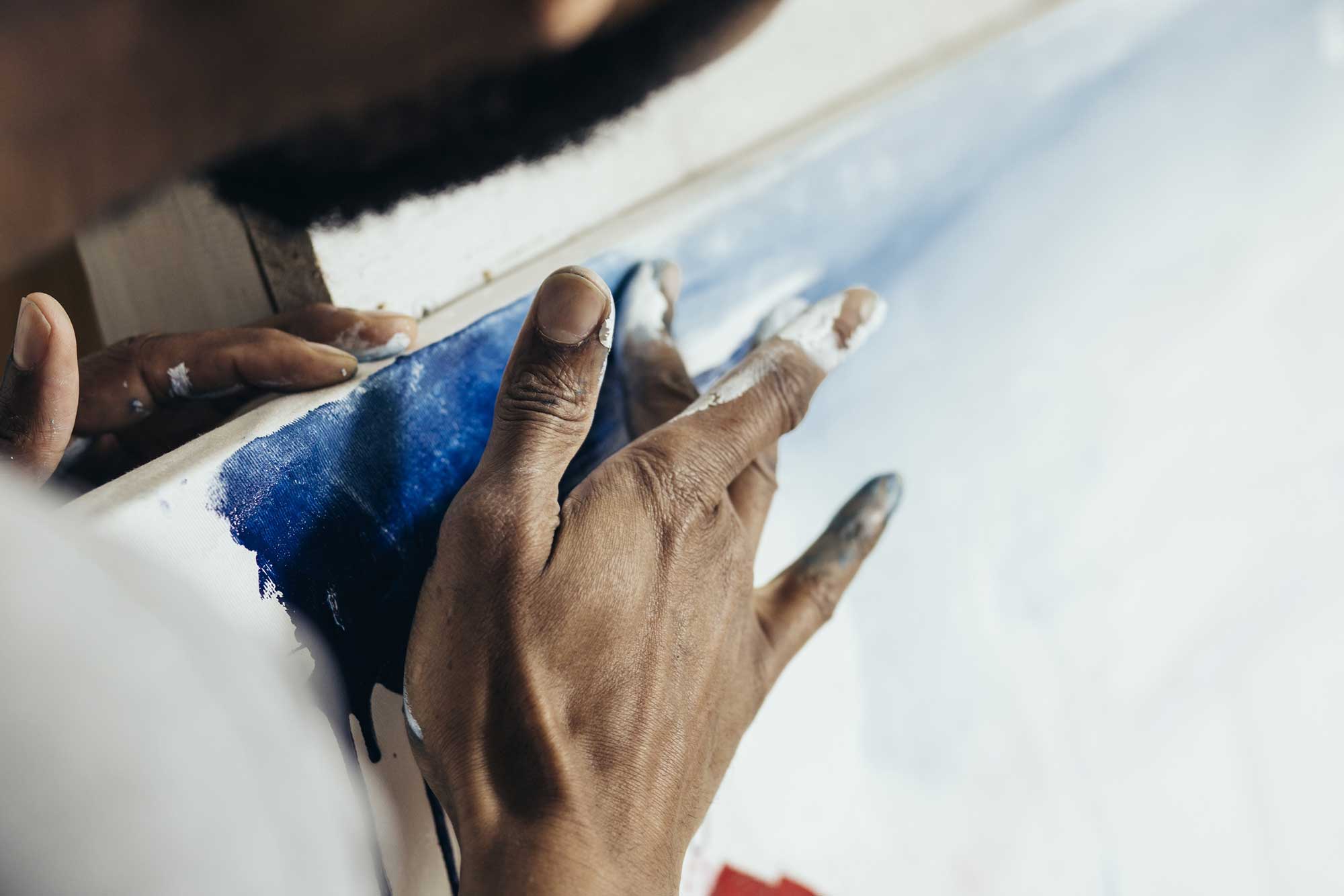 Artist using blue paint