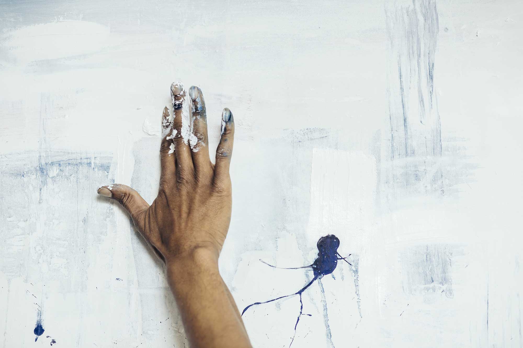 Artist painting on a white canvas