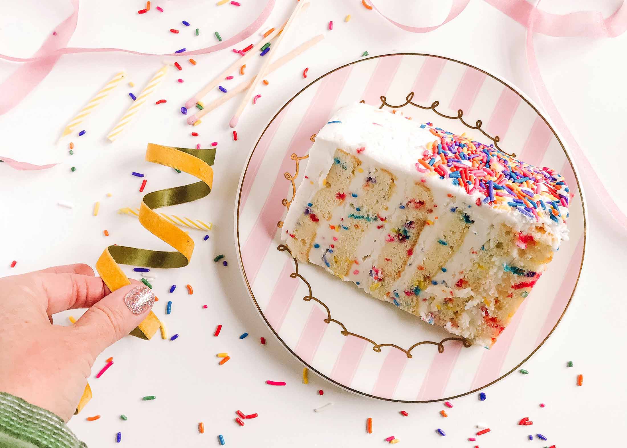 Slice of cake with streamers and sprinkles