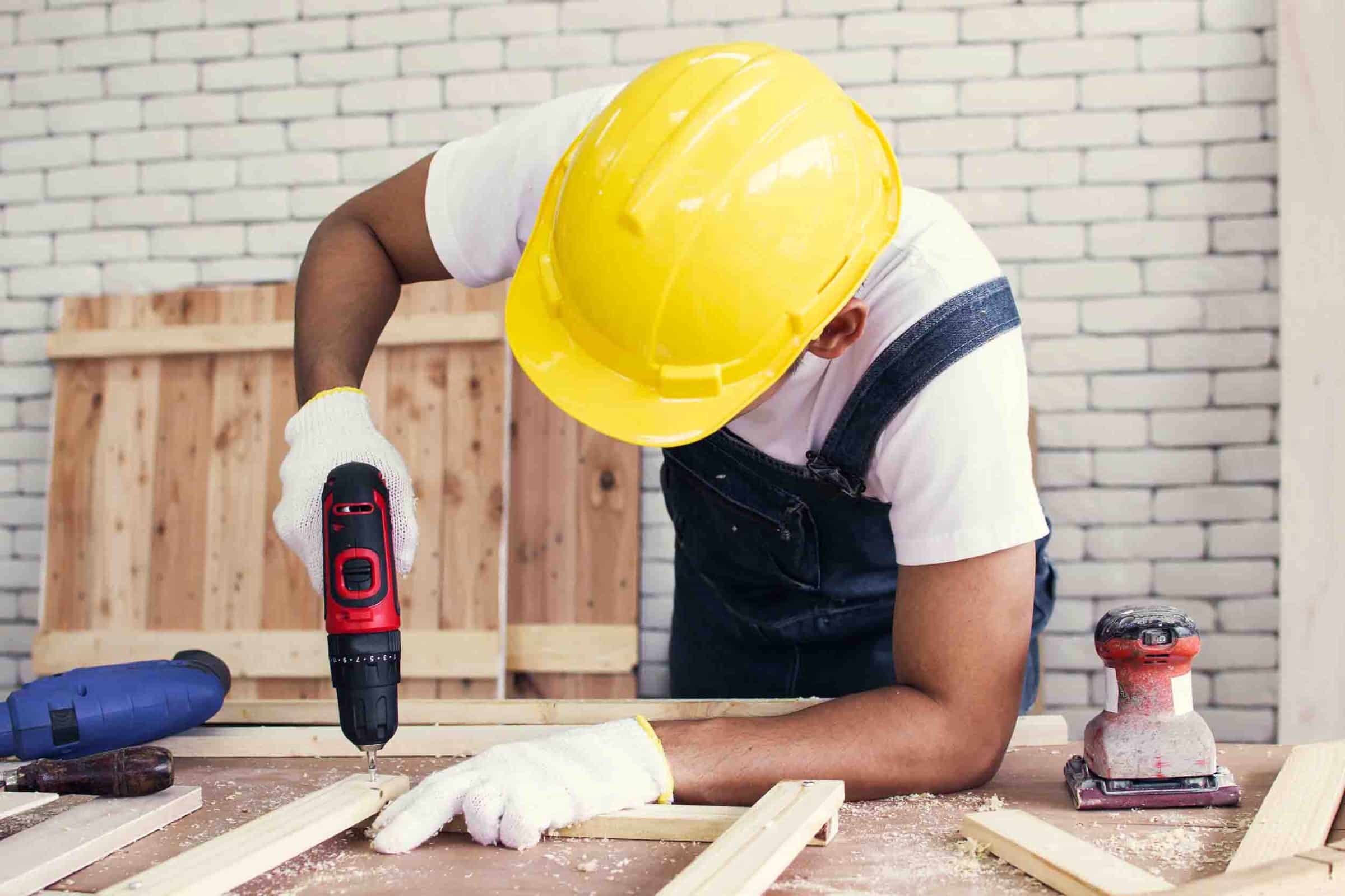 Construction worker drilling into wood